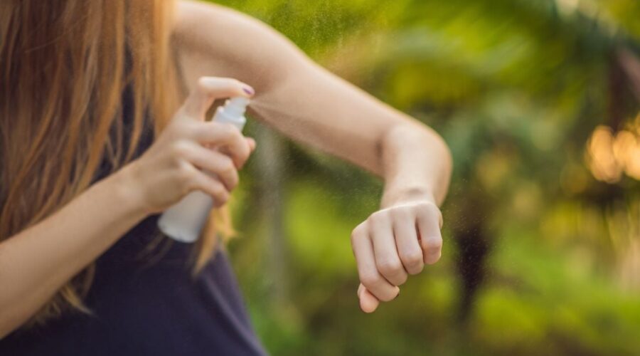 mujer colocandose repelente para mosquitos